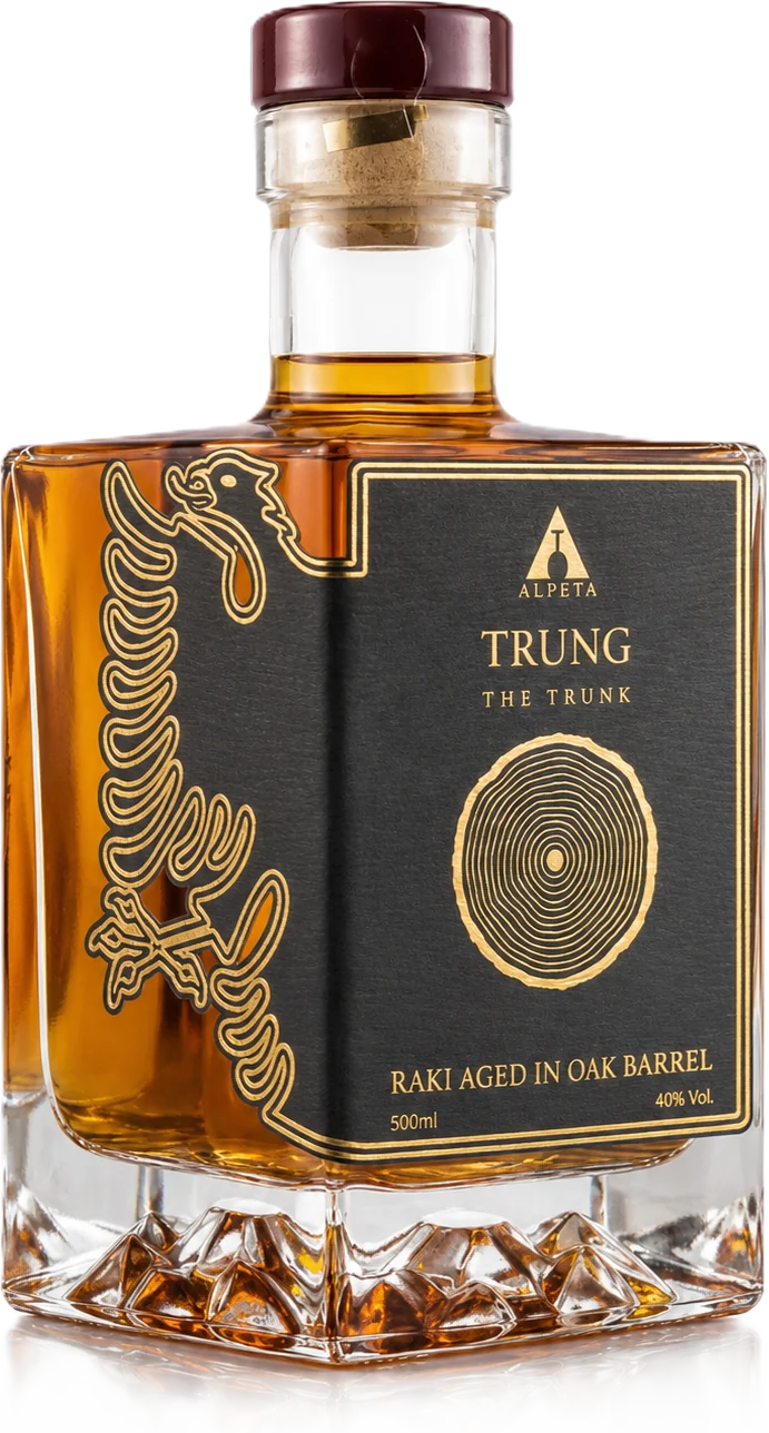 Bottle of Trung raki aged in oak: amber spirit in a square decanter with a black and gold label showing tree rings